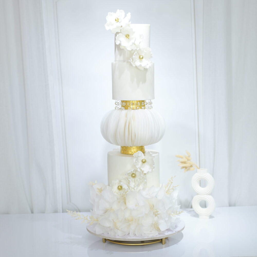 Unique Alfajores Luxury Wedding Cake, inspired by Latin American treats, with layers of buttery cake and dulce de leche filling.