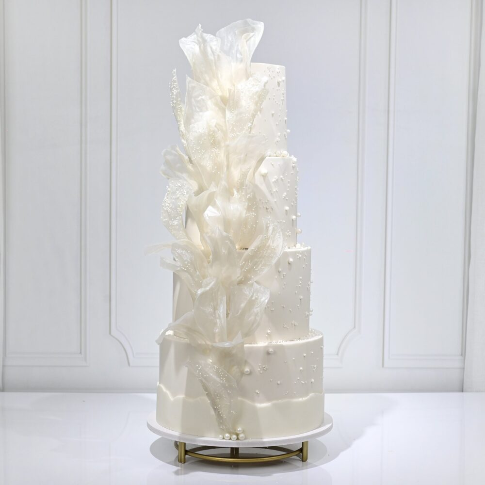 Opulent Fakhamah Luxury Wedding Cake, a multi-tiered masterpiece with intricate sugar detailing and floral arrangements.